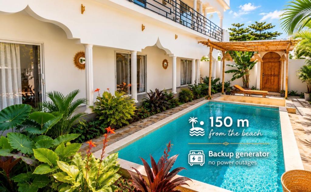 a villa with a swimming pool in front of a house at Mayssa Villa in Paje