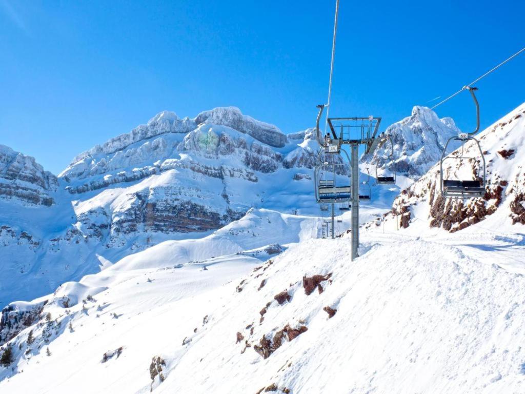 a ski lift on top of a snow covered mountain at SOLOPUENT Hotel Rural in Castiello de Jaca