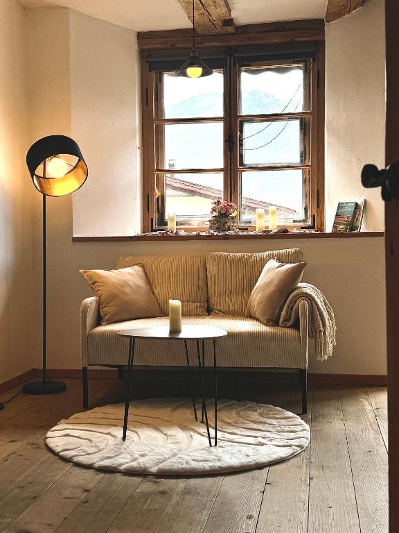 a living room with a couch and a table at s'Morent in Zöblen