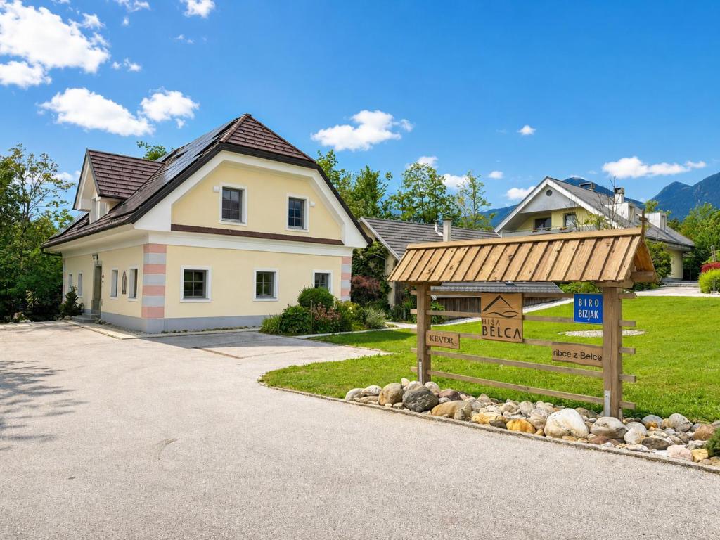a house with a sign in front of a driveway at Apartment House Belca in Preddvor
