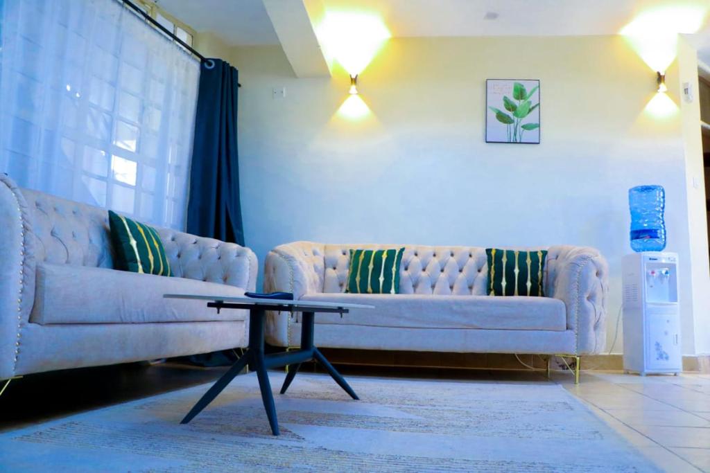 a living room with two couches and a coffee table at Dobajo Homes2 in Kisumu