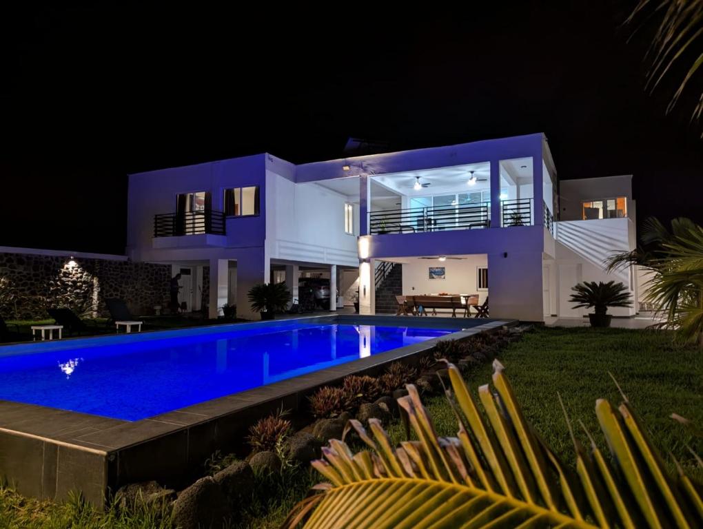 a villa with a swimming pool at night at Casa Playa Eugen beach house with pool in El Morro