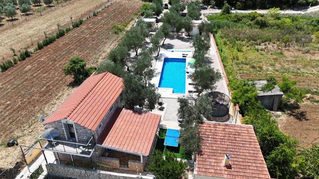 an aerial view of a house with a swimming pool at Olive Grove House in Ston