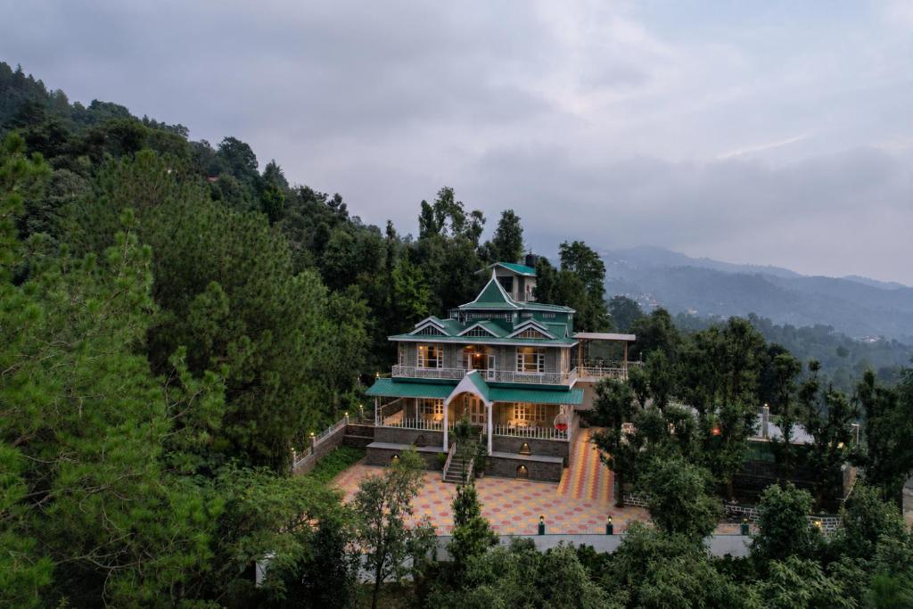 a large house on top of a hill at SaffronStays StoneVilla in Shimla