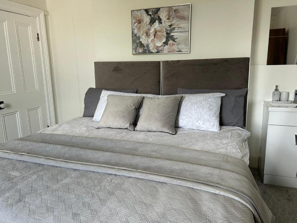 a bedroom with a large bed with two pillows at Comfortable room in Newbridge