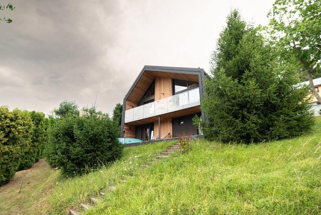 a house on top of a hill with trees at Great Lake in Nová Baňa