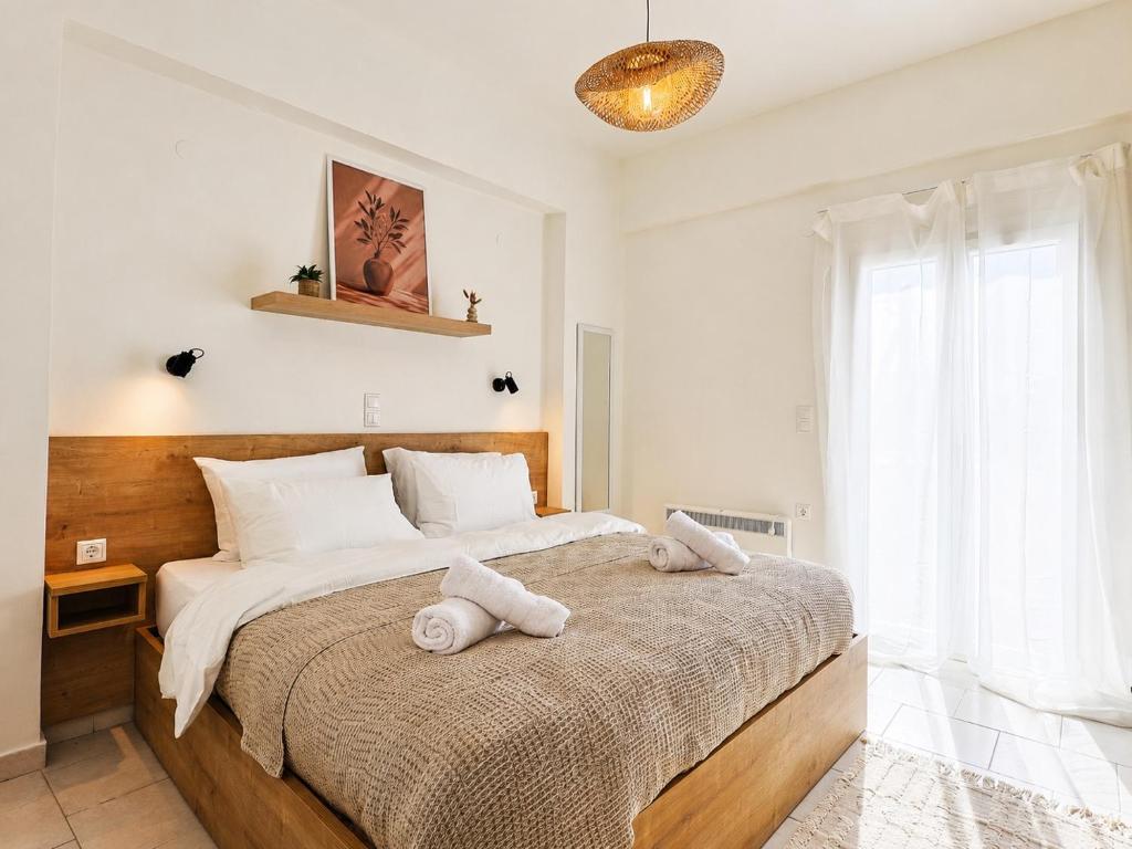 a bedroom with a large bed with towels on it at Thea Stays in Kato Gouves