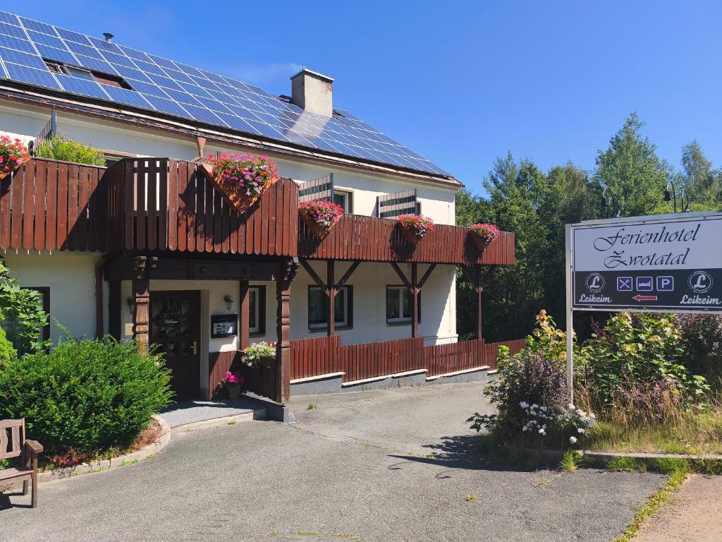 a building with solar panels on the roof at Ferienhotel Zwotatal in Klingenthal