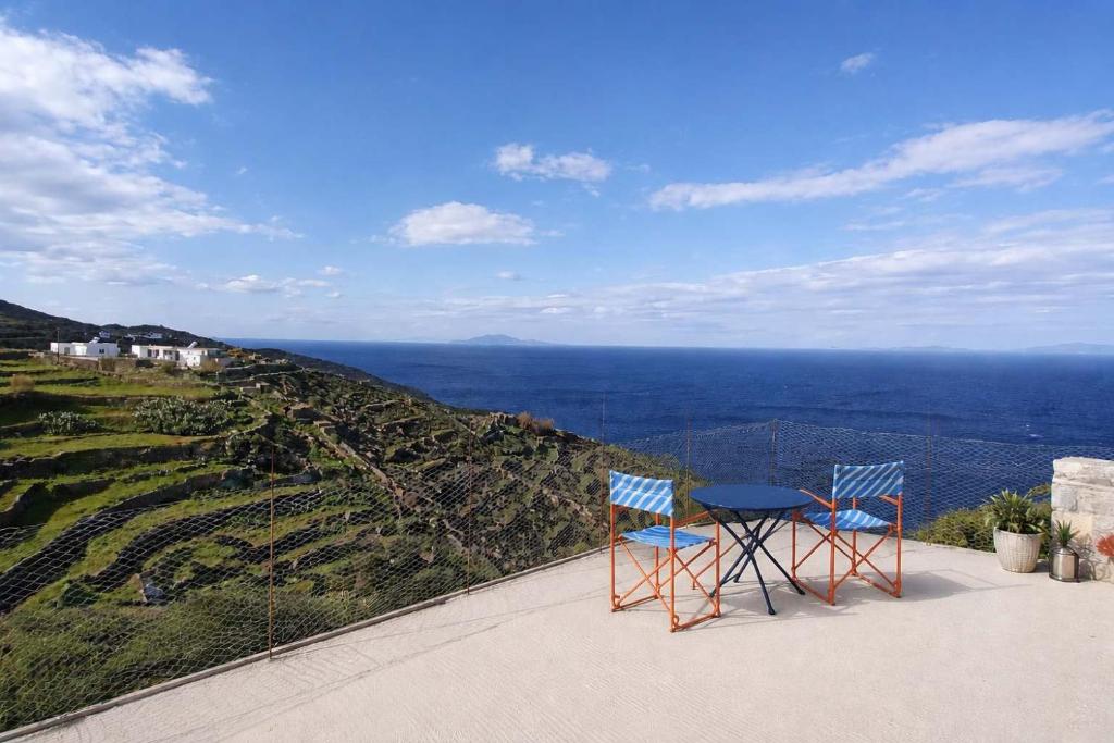 two chairs and a table on top of a mountain at Dreamy View in Folegandros in Áno Meriá