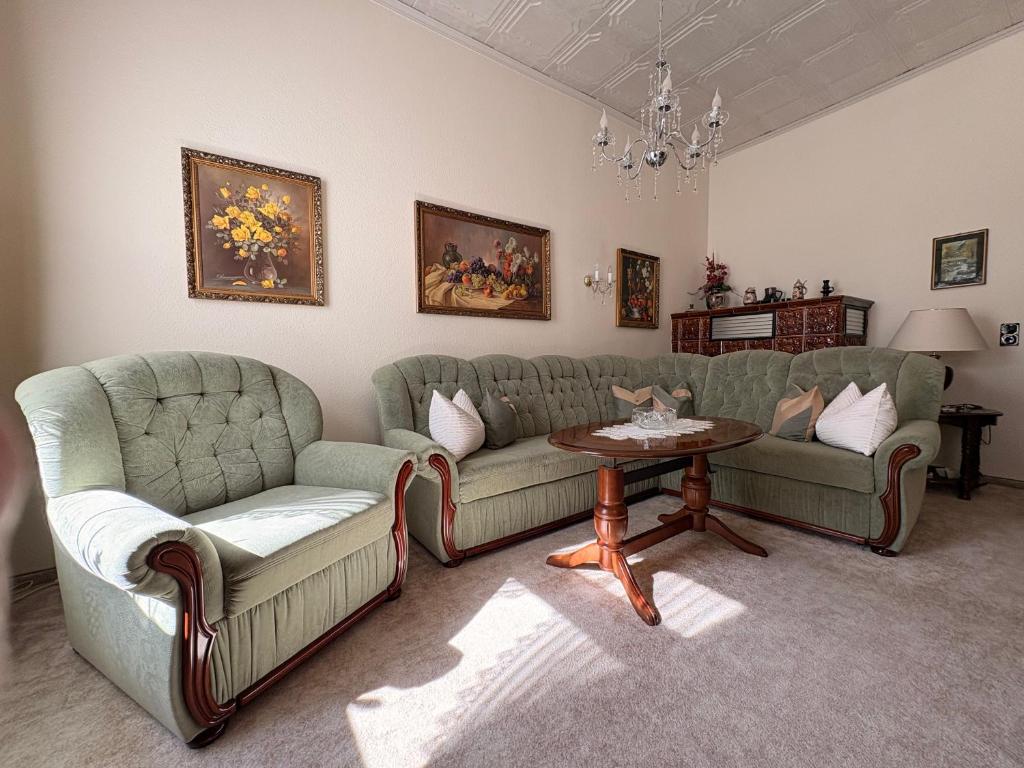 a living room with two couches and a table at Ferienwohnung Heidi in Annaberg-Buchholz
