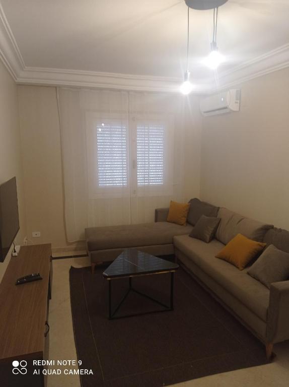 a living room with a couch and a table at Appartement Bizerte Nord in Bizerte