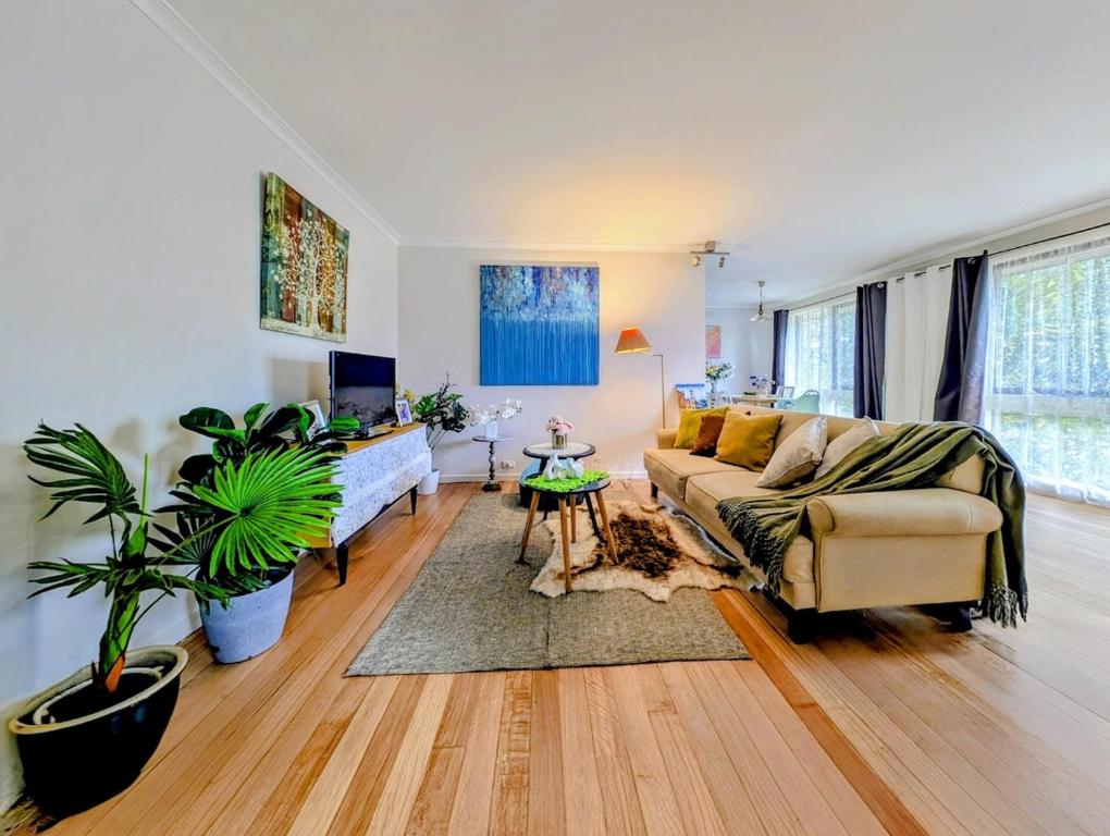 a living room with a couch and a table at Star House in Mitcham