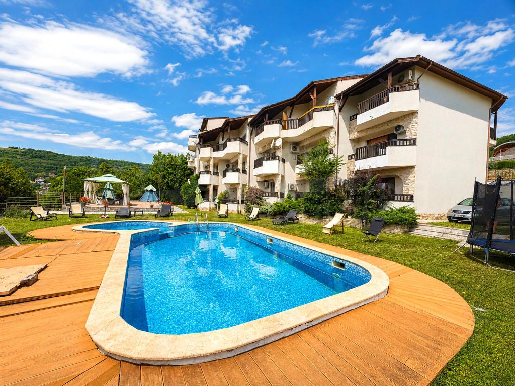 a swimming pool in front of a building at Morski Briz in Balchik