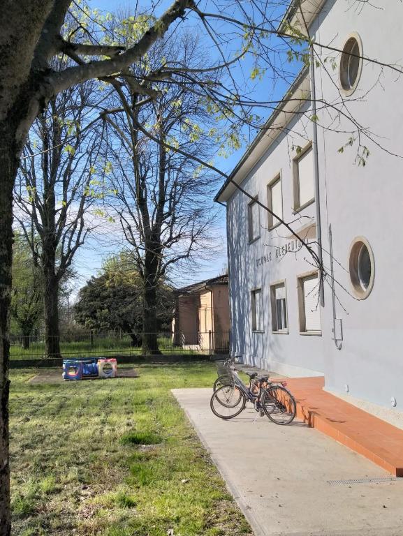 a couple of bikes parked outside of a building at Ostello Postumia in Torre deʼ Picenardi