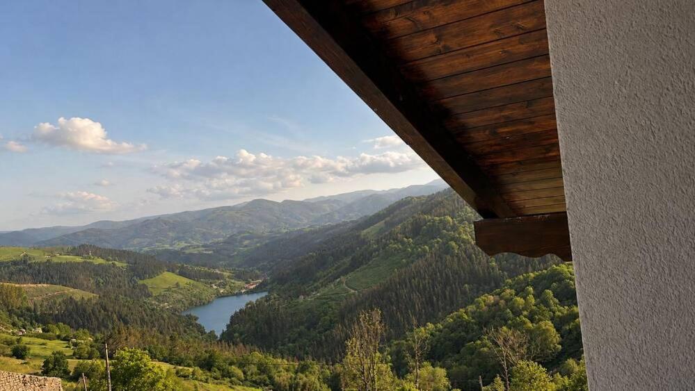 a view of a valley with a river and mountains at Kamiñone Landetxea in Beasain
