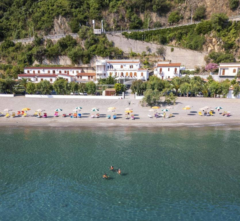 a group of people in the water at a beach at Testa di Monaco - Basic Beach Accommodations in Capo dʼOrlando