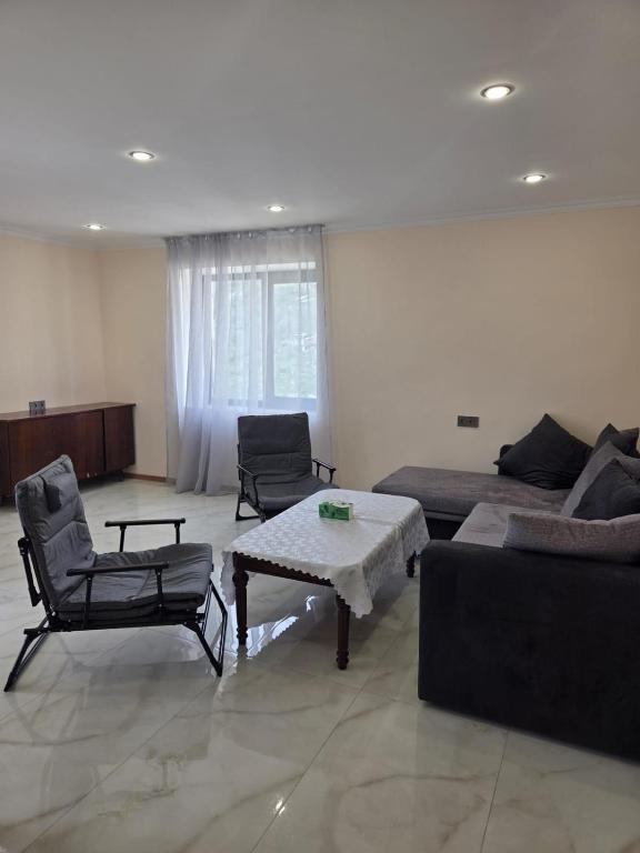 a living room with a couch and a table and chairs at hyuratun Shamlugh in Shamlugh