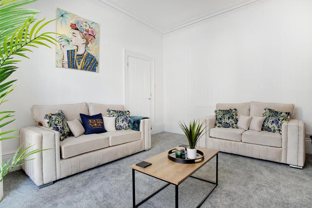 a living room with two couches and a coffee table at Spacious 4BR retreat Eden Vale by Stay With Us in Sunderland