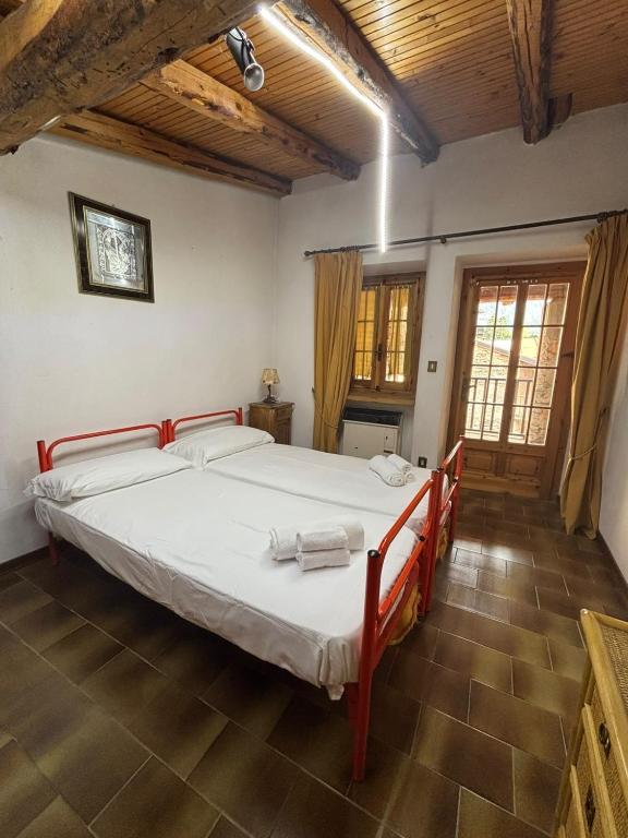a bedroom with a large bed in a room at Vecchio Mulino- Via Paier in Entracque