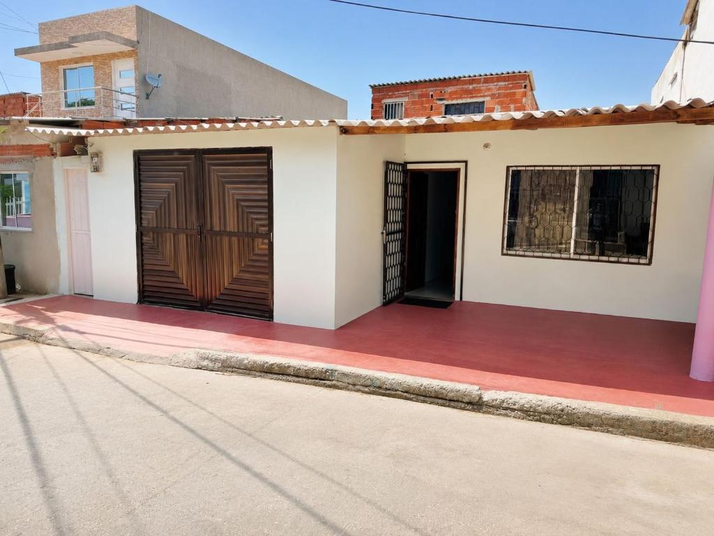 a house with two garage doors on a street at Hostal Puerto del Reino in Puerto Colombia