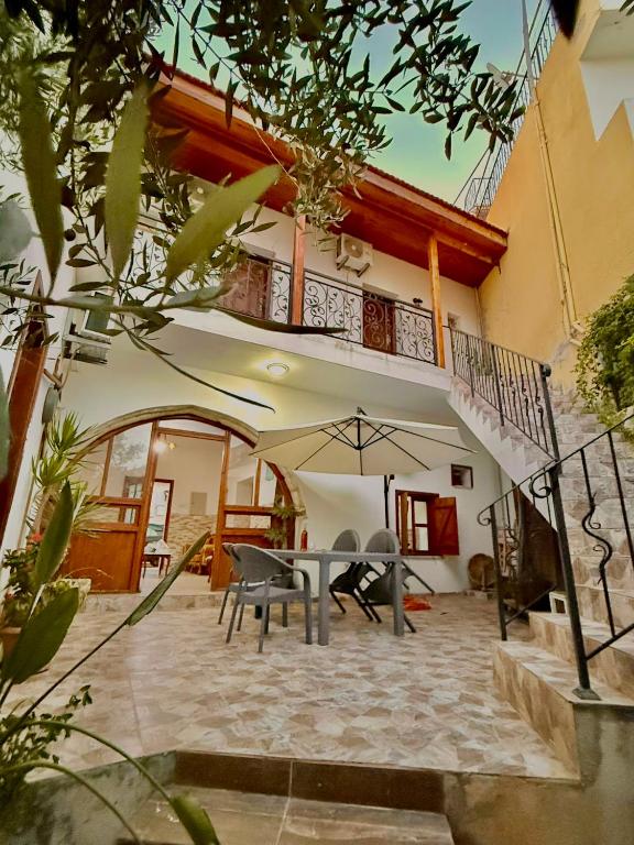 a house with a patio with a table and a balcony at MAGIC MOON guest house in Famagusta