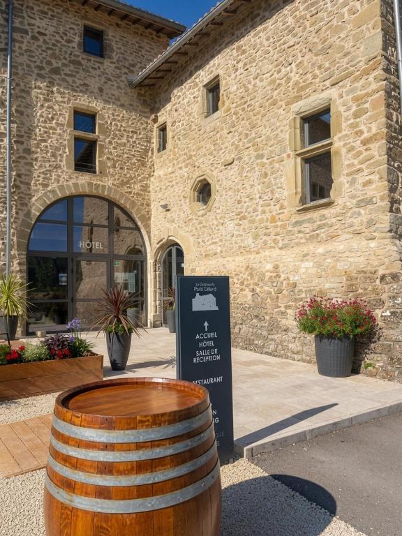 a large barrel in front of a building at Château du Poët-Célard in Le Poët-Célard