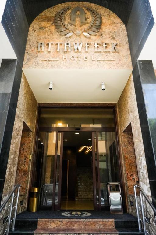 an entrance to a building with a sign on it at Attawfeek Hotel in Tripoli