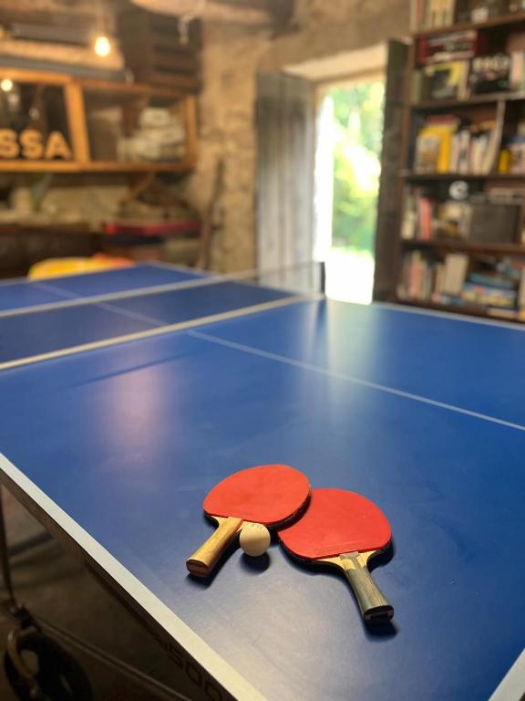 two ping pong paddles on top of a table at La minada in Covelo