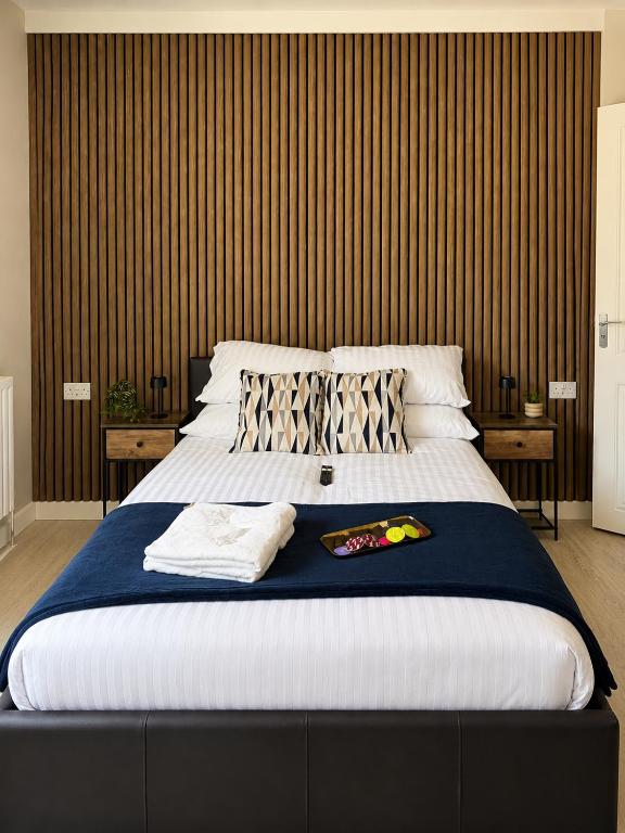 a bedroom with a large bed with a blue blanket at Wellingborough Luxury Staycation 3 Bed 2 Bath in Wellingborough