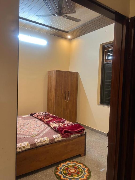 a bedroom with a bed and a wooden cabinet at lavender hill in Jaipur