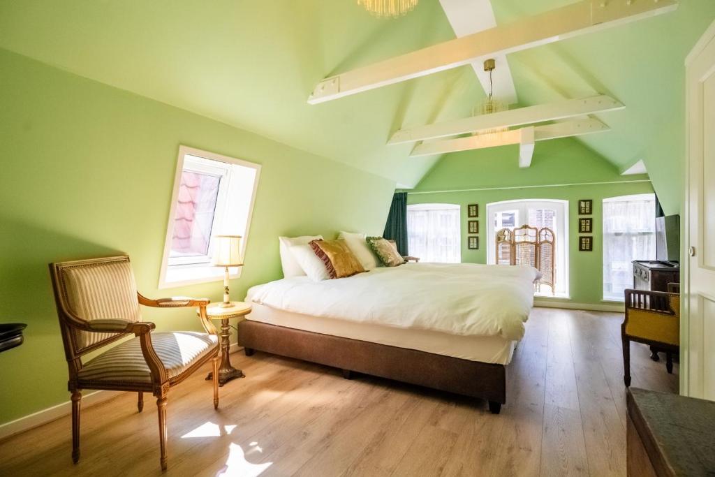 a green bedroom with a bed and a chair at Hotel Bet van Beeren in Amsterdam