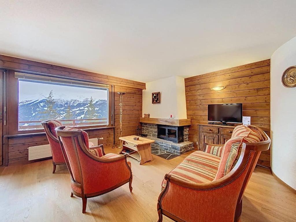a living room with a couch and chairs and a television at Tayannes 222 in Verbier