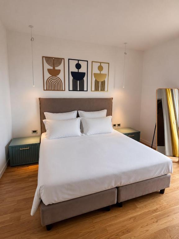 a bedroom with a large bed with white sheets at Amaurusa Boutique Hotel in Taormina