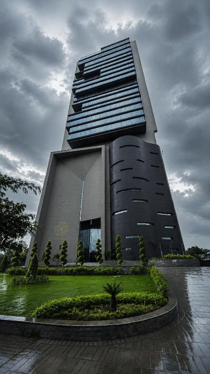 a large building with a lot of windows at The Vista 1BR by Winchester in Mall of Islamabad F-7 Margalla & City Views in Islamabad