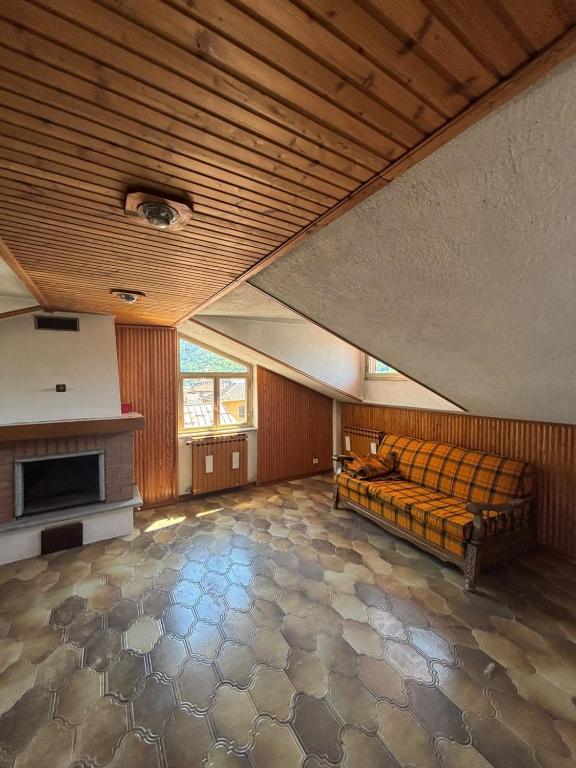 a large room with a bed and a fireplace at La Mansarda del Vecchio Mulino in Entracque