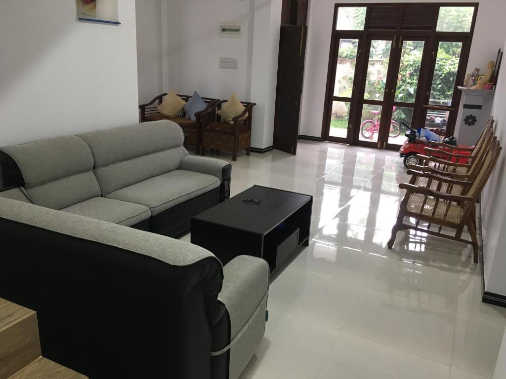 a living room with a couch and a table at Bosadi Apartment katunayaka in Katunayaka