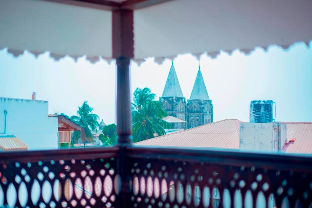 a balcony with a view of a church at ZANZInest Apartment in Kituoni