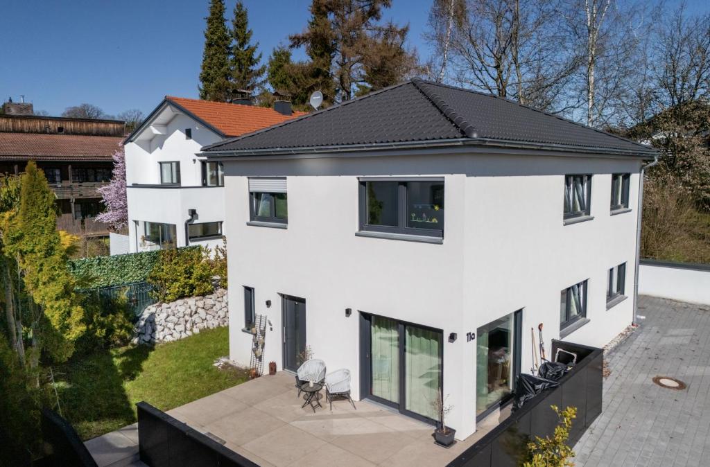 an aerial view of a white house with a black roof at 3S Holiday Home in Traunstein