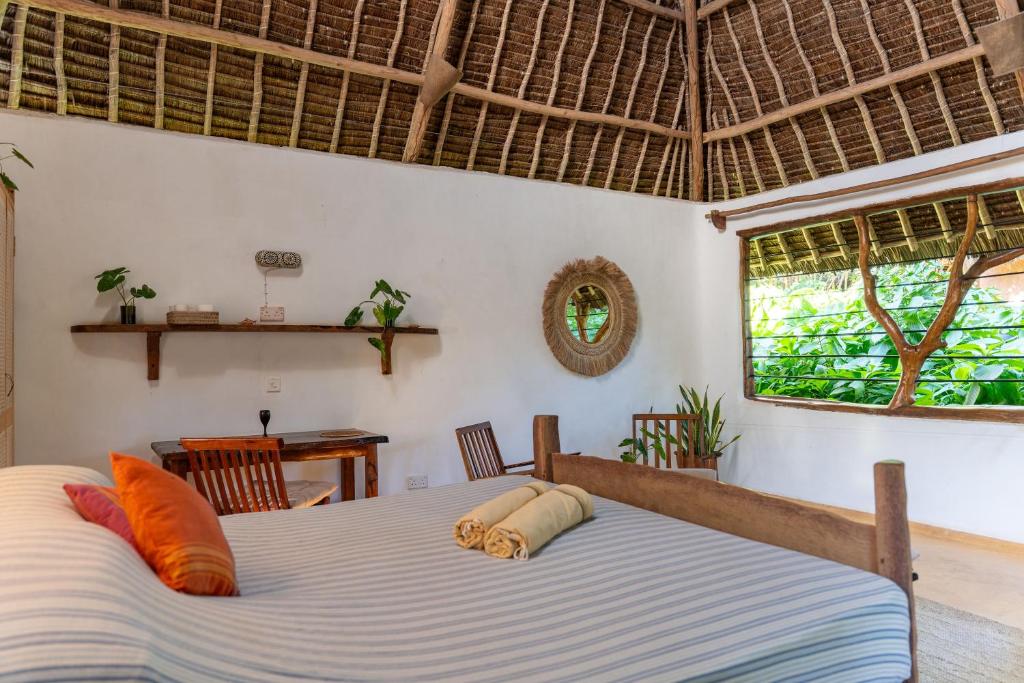 a bedroom with a bed in a room at Distant Relatives Ecolodge & Backpackers in Kilifi