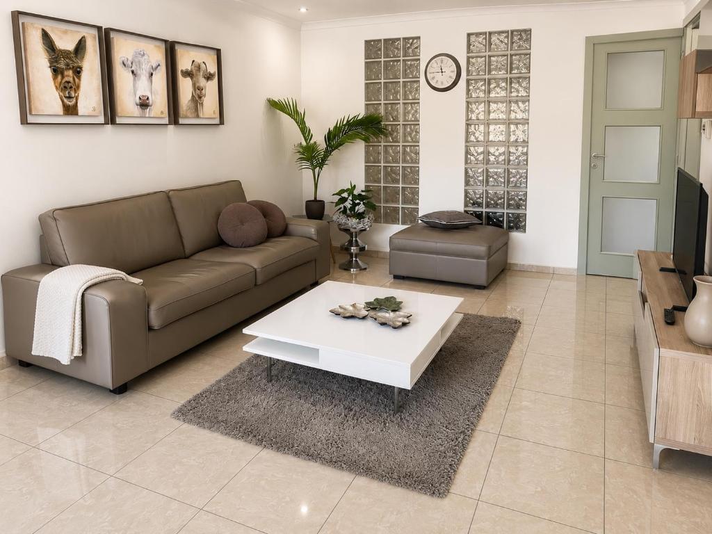 a living room with a couch and a coffee table at apartment 2 miles from Maastricht in Lanaken
