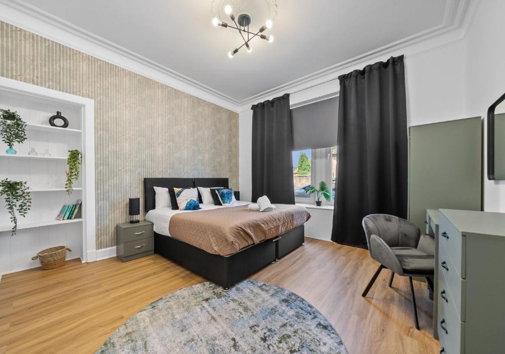 a bedroom with a bed and a chair at Albion Apartment by Klass Living Coatbridge in Coatbridge