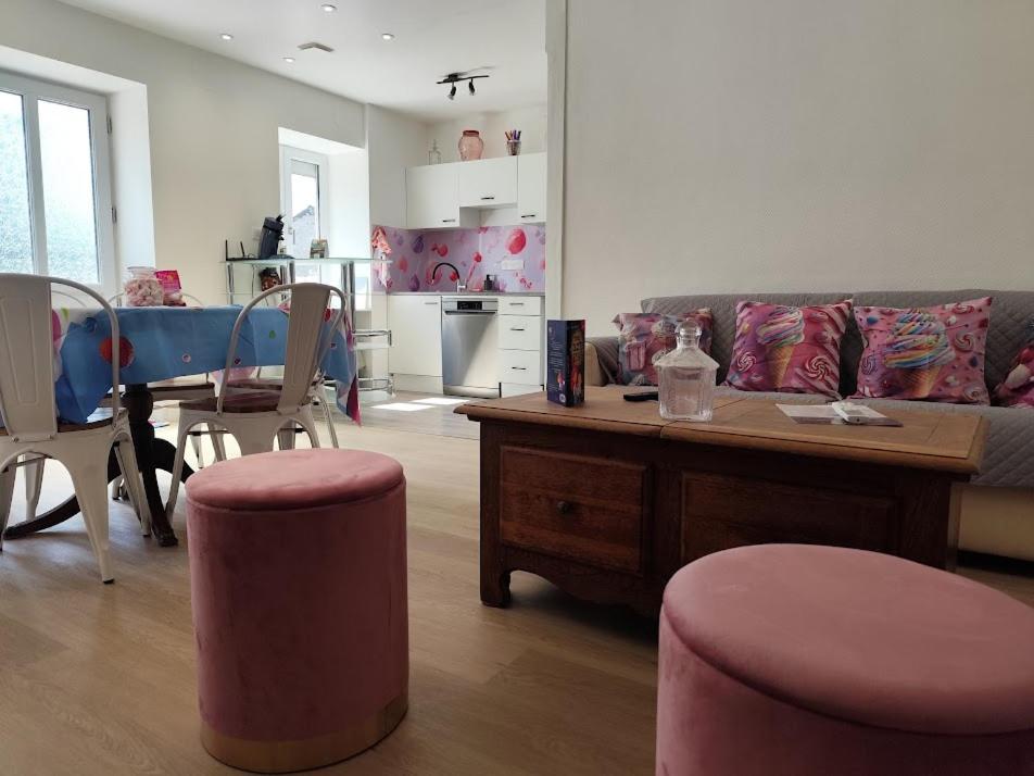 a living room with a couch and a table at Candyland in Argançon