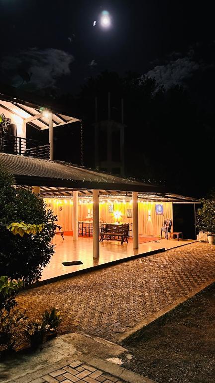 a building with a lit up patio at night at Yala Zafiro in Kataragama