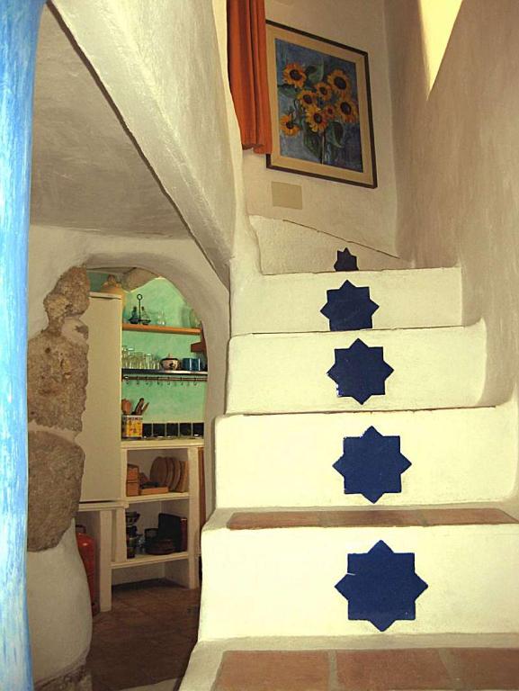 a staircase in a house with blue stars on it at La Muralla in Yunquera