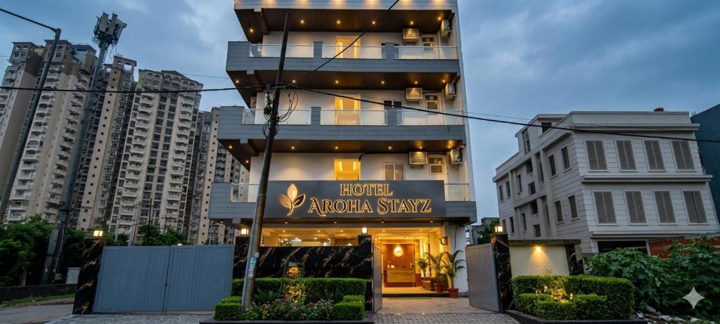 a building with a sign that reads acrocorax stay at Hotel Aroha Stayz At Sector 44 Noida in Noida