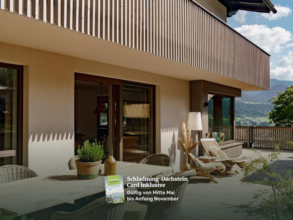 a house with a patio with chairs and a table at CHILL HOUSE in Schladming