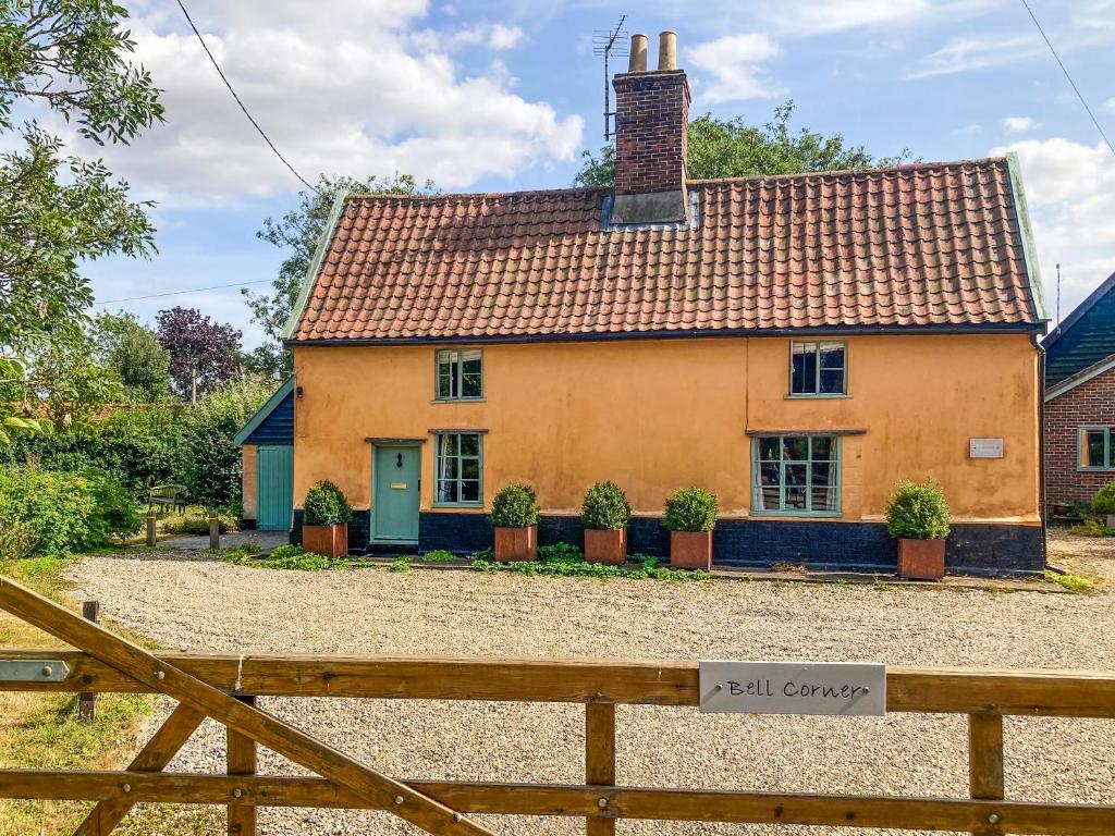 a yellow house with a red roof at Bell Corner Cottage in Cratfield