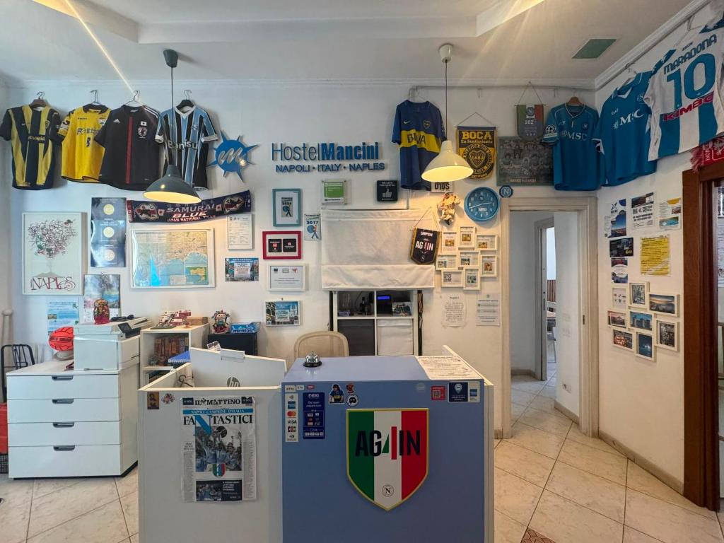 a room with a wall covered in baseball uniforms at Hostel Mancini Naples in Naples