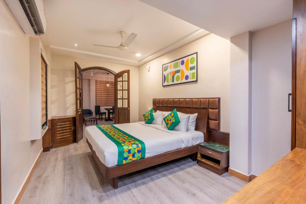 a hotel room with a bed and a table at Treebo Planet Mount Near US Consulate Anna Salai in Chennai