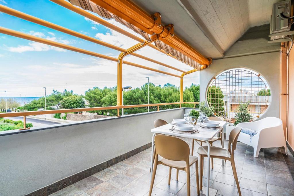 a dining room with a table and chairs on a balcony at Casa Eos in Bari